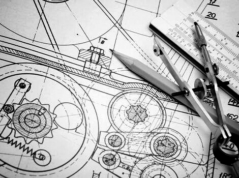 A mechanical drawing with a drawing compass, pencil, and ruler on top of the drawing on the right side.