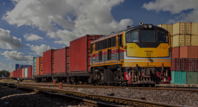 A train in a train yard illustrating the word rail.